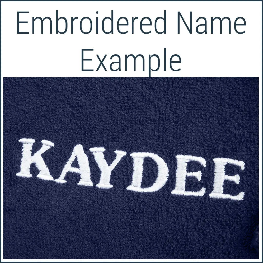 Close-up of a navy Dogrobe MAX dog drying robe personalised with an embroidered name in white thread