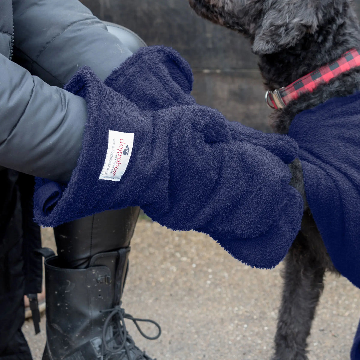 Close-up of Navy Dogrobes Dog Drying Gauntlets (mitts) being used to dry a wet Labradoodle's legs and paws