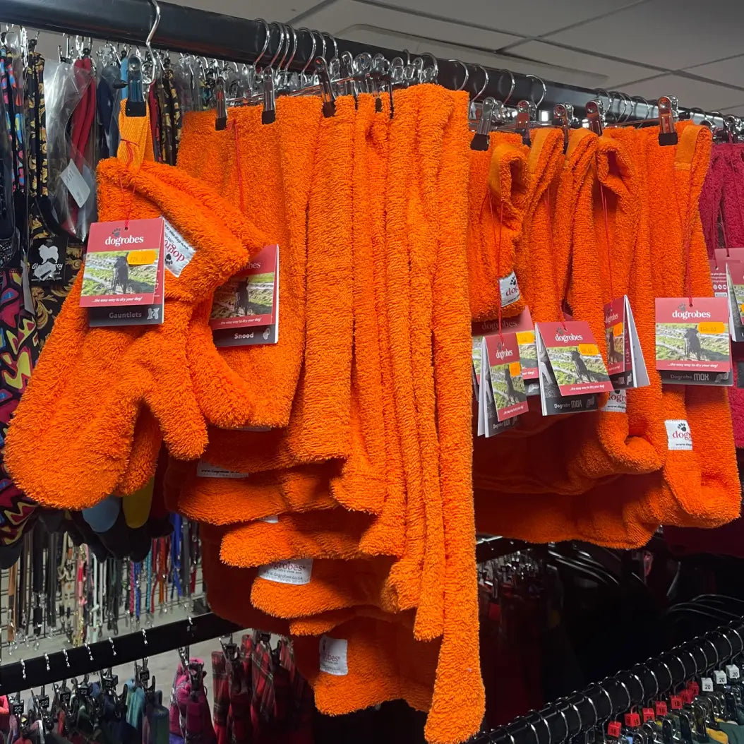 Orange Dogrobe MAX coats, Snoods and Gauntlets displayed in a pet shop