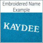Close-up of a teal Dogrobe MAX dog drying robe personalised with an embroidered name in white thread