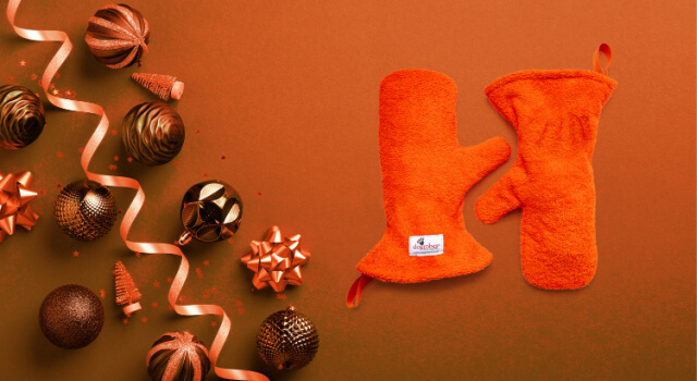 Orange Gauntlets, Dogrobes' dog drying mitts, on an orange background with Christmas baubles