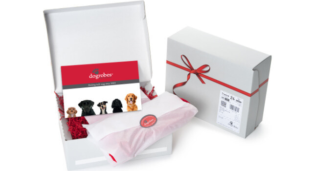 dogrobes-gift-box-packaging-red-bow-festive-wrapping Dogrobes gift box with red bow and festive wrapping, showing how orders are presented when sent as a gift