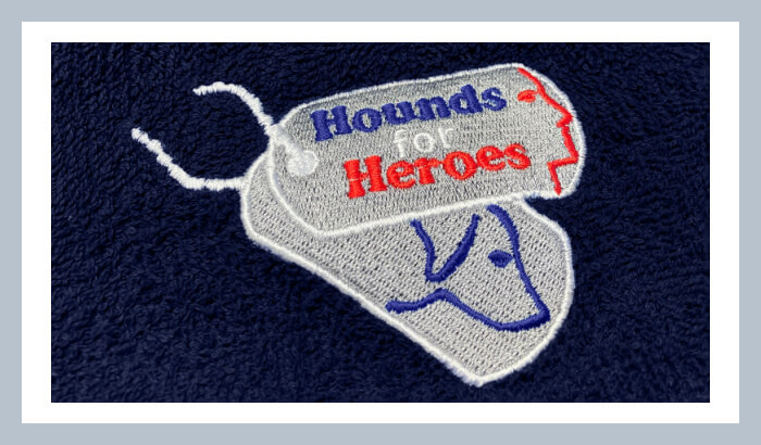 Navy suuper-absorbent fabric from Dogrobes, with Hounds for Heroes embroidered dog tags' logo. 