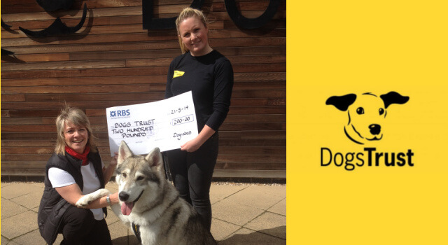 Margaret Reynolds from Dogrobes presents cheque to Dogs Trust volunteer and rescued dog